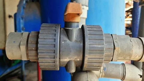 Close up of a weathered PVC ball valve with open close indicator Stock Footage 337675864