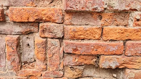 Close-up of weathered red brick wall texture with uneven antique masonry. Stock Footage 346654270