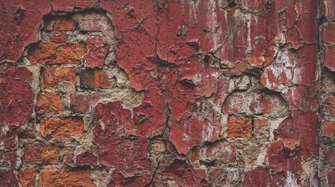 Close up of a weathered red brick wall with peeling paint. Fotos Stock