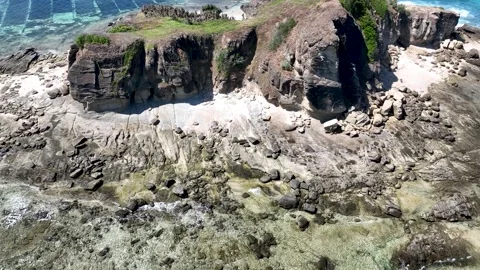 Close up of weathered rock formations and scattered boulders at the base of Stock Footage 311203336