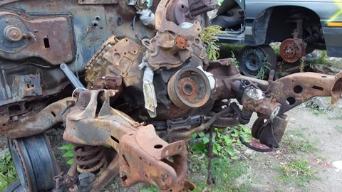 Close-up of a weathered, rusty car part in an automotive graveyard Stock-Footage 256079473