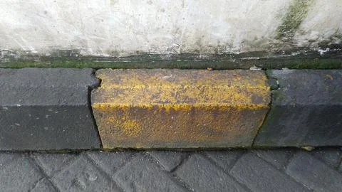 Close-up of a weathered, rusty metal pipe with yellow markings. Stock Photos