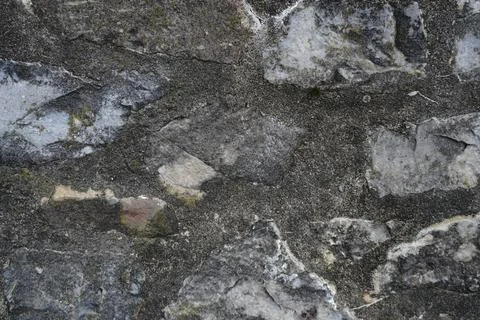 Close-up of a weathered stone wall texture Stock Photos