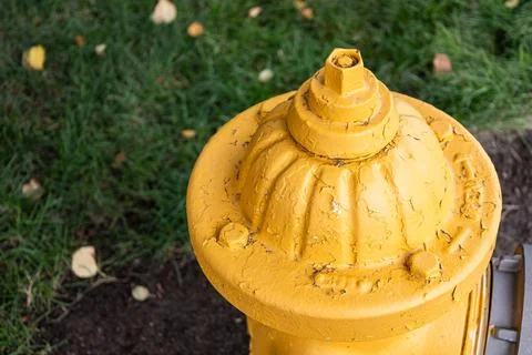 Close-up of weathered yellow fire hydrant with peeling paint Stock Photos