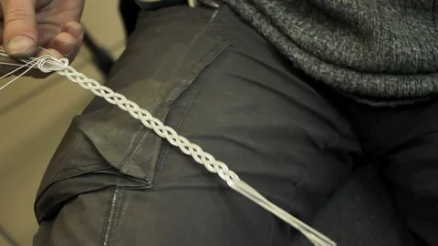 Close-up of weaving a silver bracelet, the hands of a master jeweler Stock Footage 126726328