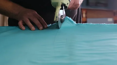 Close-up of Weaving Table. Man's Hand. Circular Saw. Blue Cloth. Layout for Crop Stock Footage 146107030