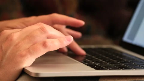Close up of a web designer's hands working hard on a laptop Stock Footage 235769385