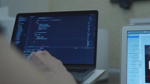 Close-up of web developer's hands programming Javascript, coding HTML on laptop Stock Footage