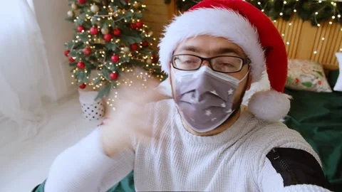 Close-up of a webcam - a portrait of a positive guy who sits near a decorated Stock Footage 165384215