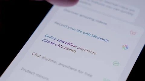 Close-up of the WeChat app being opened and briefly used on a smartphone in a Stock Footage 337241477