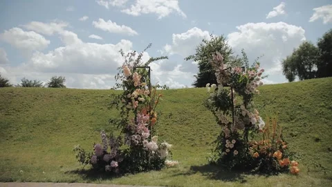 Close-up of wedding arch decorated with flowers, outside wedding ceremony Stock Footage 307299535