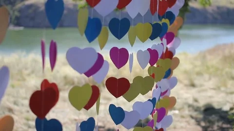 Close up of wedding arch made of hearts on a string sway in the wind Stock Footage 73727658