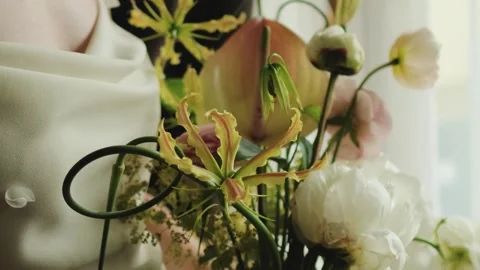 Close-up of a wedding bouquet held by the bride. Bouquet of white, yellow and Stock Footage 323398560