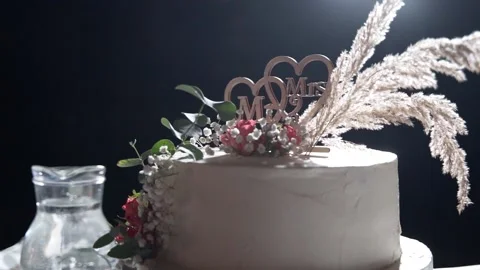 Close-up of a wedding cake in the night light, decorated with Mr. and Mrs Stock Footage 239734029