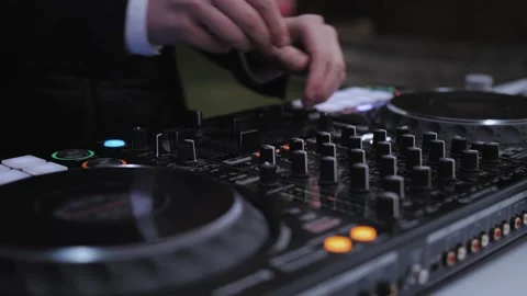 Close-up of Wedding DJ man play and adjust controller with vinyl on the wedding Stock Footage 308724969