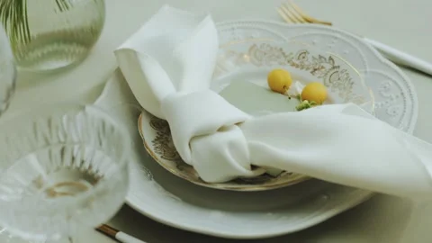 Close-up of a wedding festive table, with a white plate, glasses, decorated Stock Footage 308398083