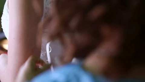 Close-up, wedding, girlfriend helps the bride to dress the wedding dress Stock Footage 99365695