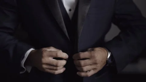Close-up. Wedding. Man fastens a button on a classic blue jacket Stock Footage 172377297