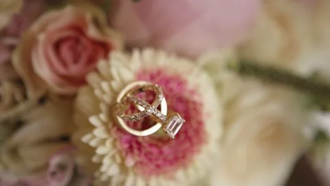 Close up of wedding ring on pastel colored flowers. Moving camera Stock Footage 135229823