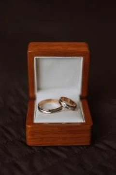 Close-Up Of Wedding Rings In Box On Table. wedding rings. Two golden weddin.. Stock Photos