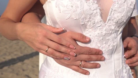 Close up of wedding rings in the hands of a just married couple Stock Footage 121333364