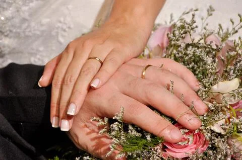 Close-up of wedding rings on hands Stock Photos
