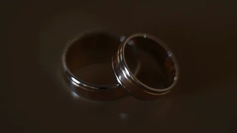 Close-up, wedding rings on the table are illuminated with a flashlight Stock Footage 99366955