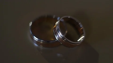 Close-up, wedding rings on the table are illuminated with a flashlight Video stock 99366971