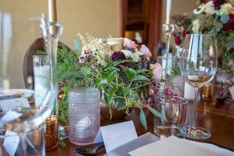Close up of wedding table set decorated with fresh flowers. Stock Photos
