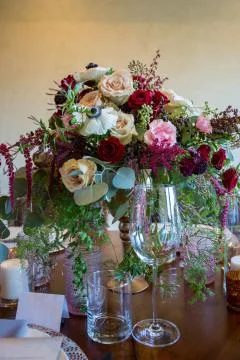 Close up of wedding table set decorated with fresh flowers. Stock Photos