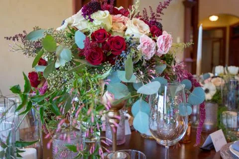 Close up of wedding table set decorated with fresh flowers. Stock Photos