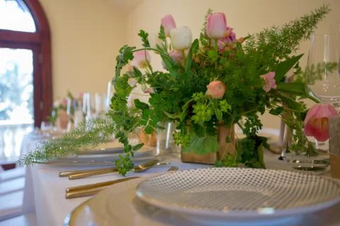 Close up of wedding table set decorated with fresh flowers. Stock Photos
