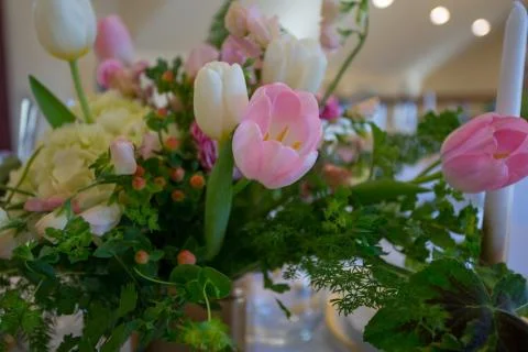 Close up of wedding table set decorated with fresh and colorful flowers. Stock Photos