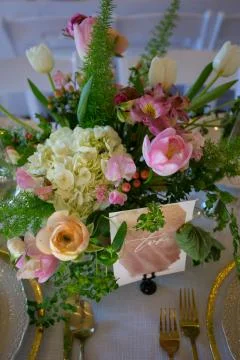 Close up of wedding table set decorated with fresh flowers. Stock Photos