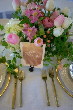 Close up of wedding table set decorated with fresh flowers. Stock Photos