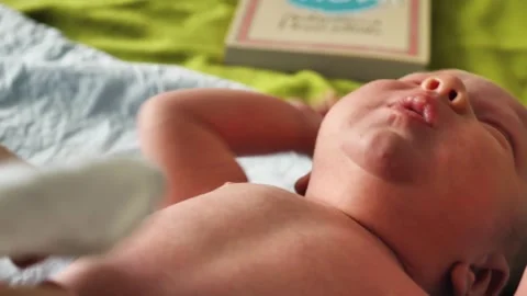 A close-up of a week-old baby crying and twitching Stock Footage 345552493