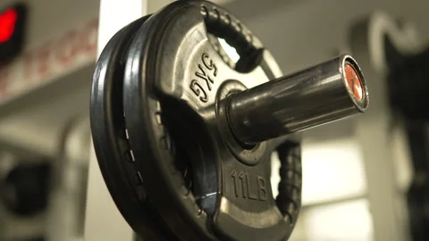 Close up on weight plate on a Smith machine in a modern gym Stock-Footage 303586505