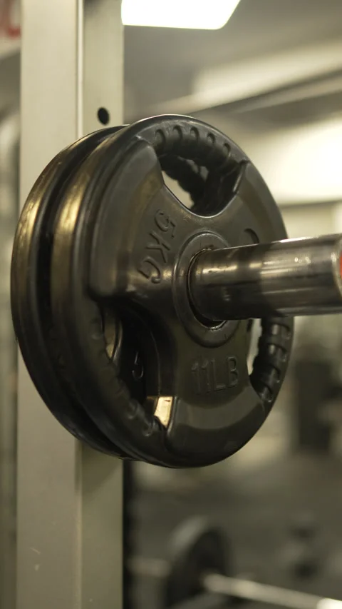 Close up on weight plate on a Smith machine in a modern gym Stock Footage 303586525