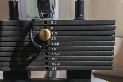 Close up of weight plates machine with yellow pin. Photos
