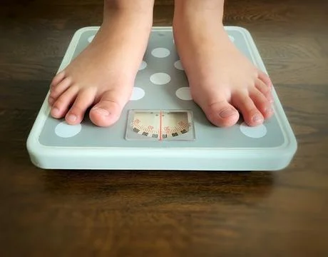 Close up of weight scale with blur surrounding background. Weight loss concept Stock Photos