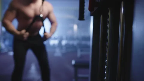 Close-up of weights being lifted by a young pumped-up athlete in defocus. Stock Footage 239008134