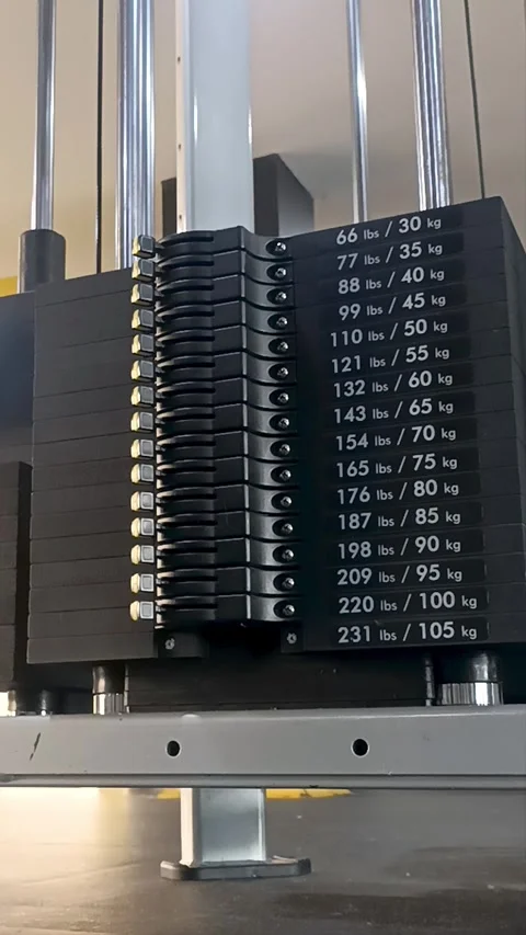 Close up to the weights of a gym equipment machine in operations Video stock 321376969