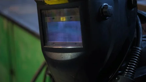 Close-up of welding equipment. Protective mask and gas cylinders in workshop Stock Footage 122570836