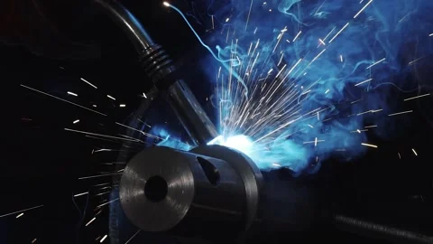 Close-up of welding by metalworker and creating blue sparks, slow motion Stock Footage 143284831