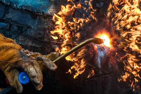 Close-up of welding process with flames and sparks in workshop Stock Photos