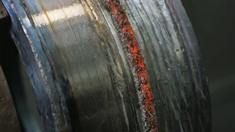 Close up of welding robots apply overlay weld protection on the pipe disks Stock Footage 84834717