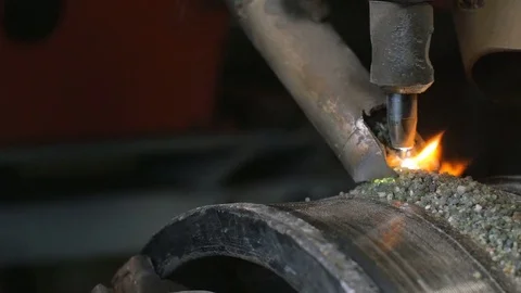 Close up of welding robots apply overlay weld protection on the pipe disks Stock Footage 84835045