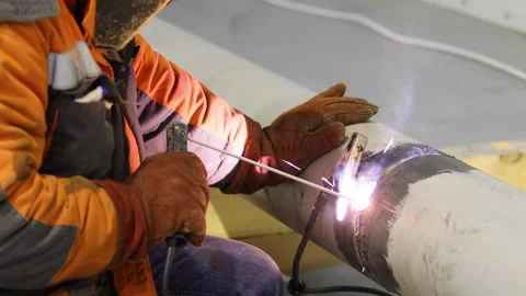 Close-up of welding work. Welder welding a pipe. Welder at a construction site Видео 320469807