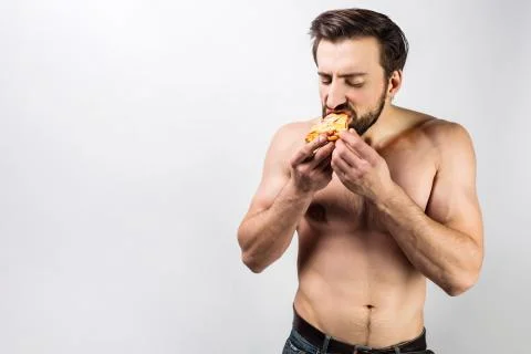 Close up of a well-built guy without a shirt vstanding near the white room an 写真素材