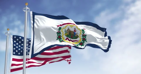 Close-up of West Virginia state flag waving in with the american flag Stock Footage 312384314